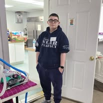 Clinic volunteer standing beside the animal prep table